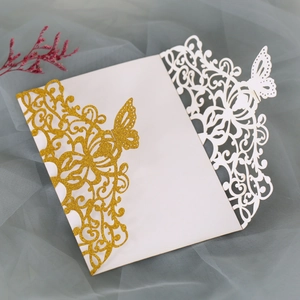 Detailed laser-cut butterfly and floral patterns on glitter gold and white invitations