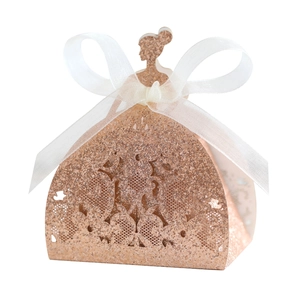 Rose gold laser-cut favor box in ball gown shape with glitter finish and ribbon