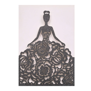 Detail showing the intricate laser-cut rose floral pattern on a black glitter card invitation