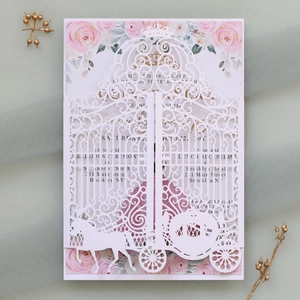 Detailed laser-cut gate and carriage pattern on white wedding invitation with floral insert