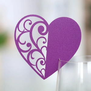 Detail of purple laser-cut heart glass card with ornate vine patterns for weddings