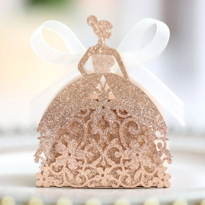 Detail view of rose gold laser-cut candy box with glitter finish and silk ribbon bow