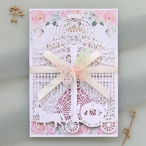 Detail of laser cut carriage wedding invitation with floral insert and 3D butterfly
