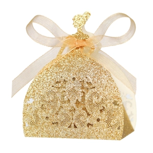 Glittering gold gown-shaped wedding favor box with champagne silk bow on white background