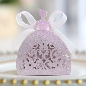 Detail of pink glitter princess favor box with laser-cut hollow pattern and white ribbon bow
