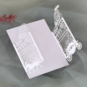 Detailed laser-cut wedding invitation featuring elegant carriage and gate designs