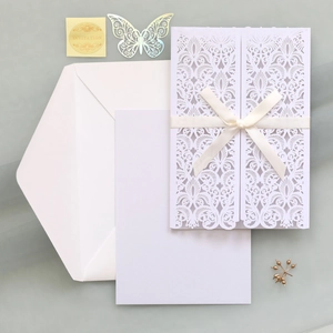 Set d'invitation de mariage découpé au laser avec ruban et sceau doré sur fond vert