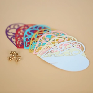 Macro view of assorted hollow laser-cut heart place cards for wedding table decor