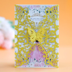 Close-up of laser-cut butterfly invitation card with gold glitter finish and floral interior