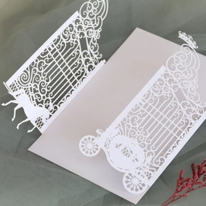 Detailed laser-cut wedding invitation featuring a horse carriage and crown motif