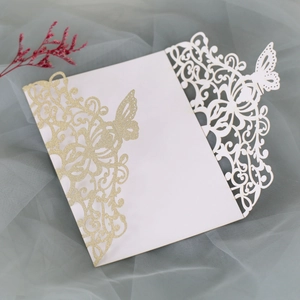 Detail of hollow laser-cut butterfly invitation with champagne glitter texture