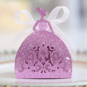 Close-up of pink glittery princess dress favor box with intricate hollow patterns and bow