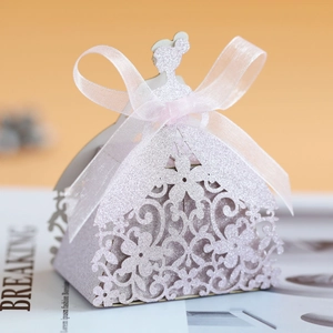 Detail of laser-cut hollow dress-shaped lavender glitter candy box with white ribbon bow