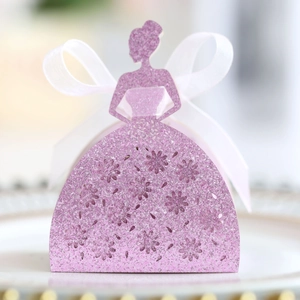 Macro detail of laser-cut lace candy box with glitter finish and white organza bow