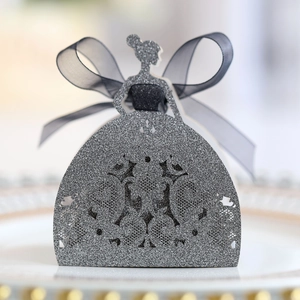 Close-up of laser-cut glitter gift box with bride silhouette and black ribbon bow