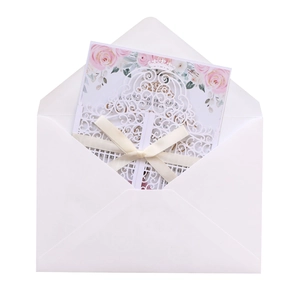 Detailed laser-cut wedding invitation with elegant ribbon bow and gold crown design