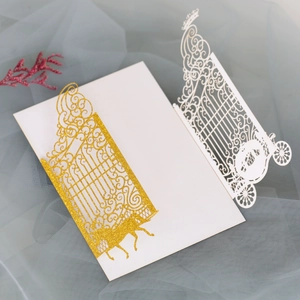 Macro detail of laser cut wedding invitation with glitter finish and carriage design