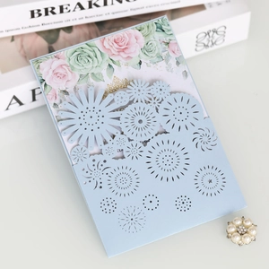 Elegant laser-cut light blue wedding invitation featuring floral hollow-out design
