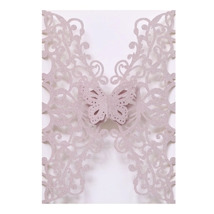 Close-up of pink glitter cardstock invitation with laser-cut butterfly and floral patterns