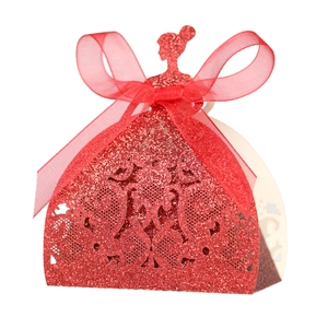 Detail of red glitter hollow candy box with laser-cut patterns and elegant ribbon bow