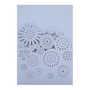 Detail of laser-cut light blue wedding invitation featuring intricate white floral patterns