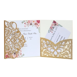 Elegant laser-cut gold glitter wedding invitation with floral insert and RSVP card