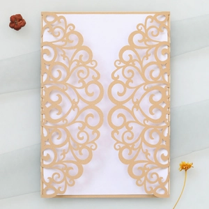 Détail de l'invitation de mariage en or perlé découpé au laser avec motifs à volutes évidés