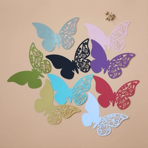 Detail of laser-cut butterfly place cards in various colors for elegant table settings