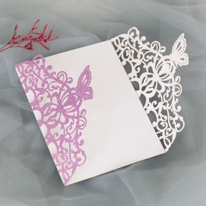 Detail of laser-cut butterfly invitation cover with purple glitter and pearl white finish