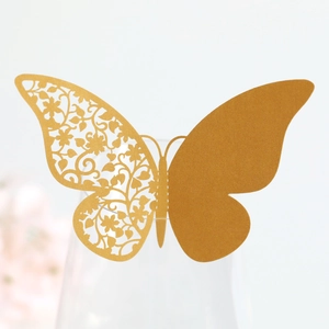 Detailed laser-cut hollow butterfly place card in gold paper for wine glass decor