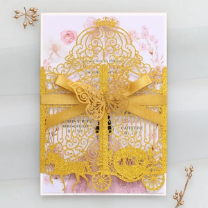 Detail of laser-cut gold glitter wedding invitation with butterfly and ribbon design