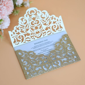 Elegant laser-cut wedding invitation card with gold glitter cover and floral background