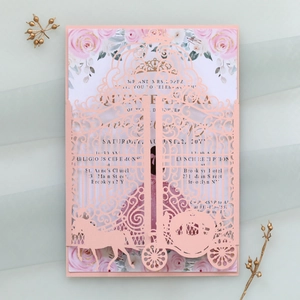 Detail of pink laser-cut wedding invitation featuring elegant horse carriage lace patterns