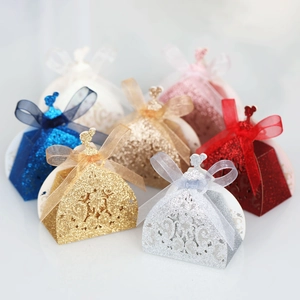 Detail of glitter hollow-out princess dress candy box with elegant ribbon bow for weddings