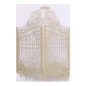 Detail view of golden glitter laser-cut wedding invitation featuring a pumpkin carriage