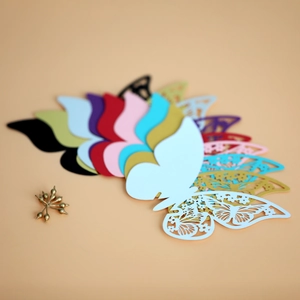 Macro shot of colorful laser-cut butterfly place cards in multiple vibrant paper shades