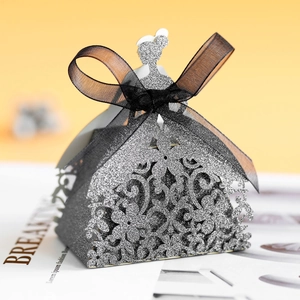 Detail of silver glitter laser-cut candy box with black mesh bow and floral patterns