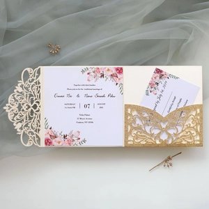 Detailed laser-cut wedding invitation set with gold glitter card and floral inserts