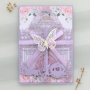Detail of laser-cut lavender wedding invitation with carriage design and purple ribbon bow