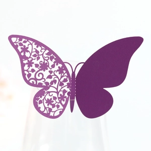Detail of laser-cut purple butterfly wine glass card with intricate hollow floral patterns