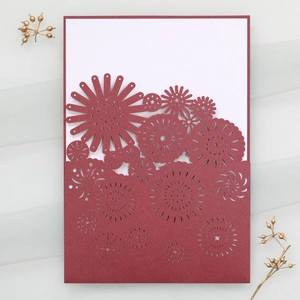 Laser-cut burgundy wedding invitation card with floral patterns on white gauze