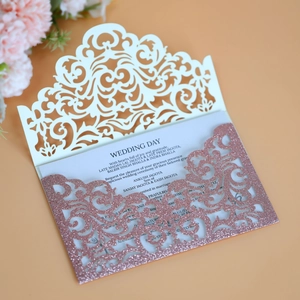 Macro detail of laser-cut wedding invitation with glitter lining on warm background