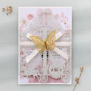 Detailed laser-cut silver glitter wedding invitation with golden 3D butterfly and ribbon