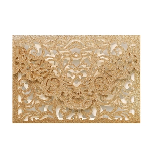 Detailed laser-cut glitter wedding invitation with golden damask floral pattern