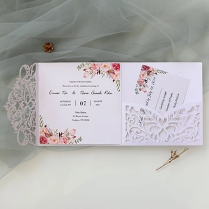 Detail eines lasergeschnittenen rosa Hochzeitseinladungs-Sets mit Blumenkarten