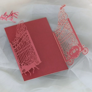 Detailed laser-cut gate and carriage design on dark red pearl paper wedding invitation