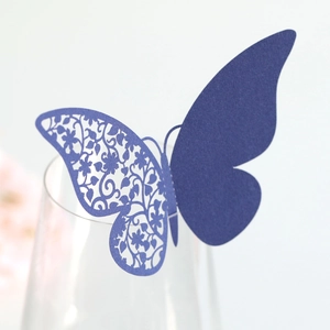 Macro detail of laser-cut purple butterfly place card for wine glass decoration