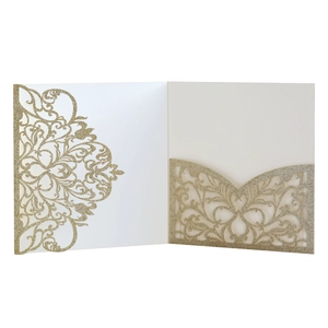 Detail of laser-cut floral patterns on gold glitter wedding invitation sleeve
