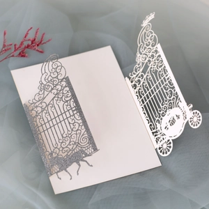 Macro detail of laser-cut wedding invitation with glitter gate and carriage patterns