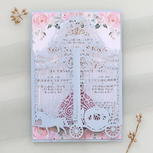 Detailed laser-cut wedding invitation featuring a pumpkin carriage and floral borders